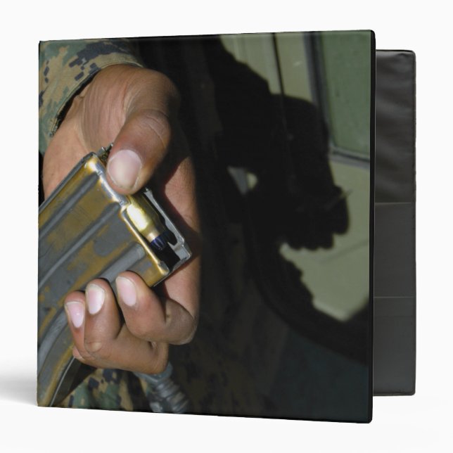 A Marine loads blank ammunition rounds Binder (Front/Inside)