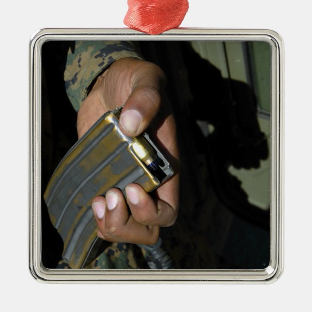 A Marine loads blank ammunition rounds Metal Ornament (Front)