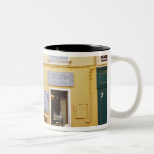 A market street in the old town with a shop Two-Tone coffee mug