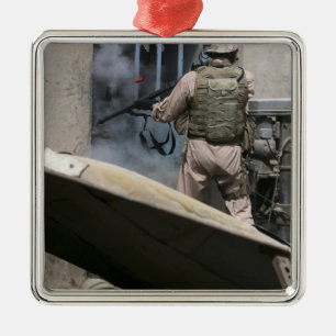 A military policeman uses a breaching round metal ornament