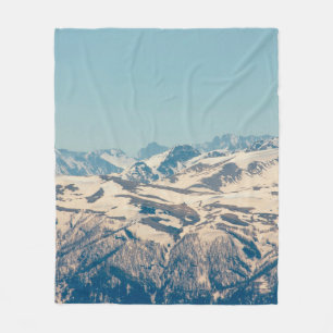 A mountain range with thawing snow and ice in the fleece blanket