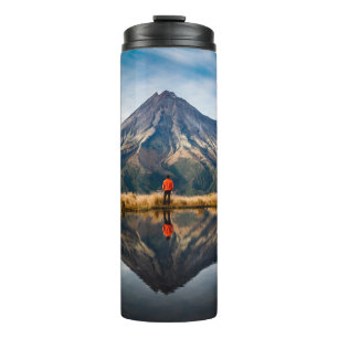 A mountaineer with an orange dress in a symmetric  thermal tumbler