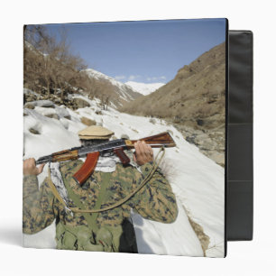 A Mujahadeen Guard walks with US Military membe Binder