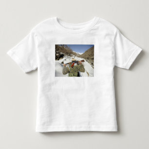 A Mujahadeen Guard walks with US Military membe Toddler T-shirt