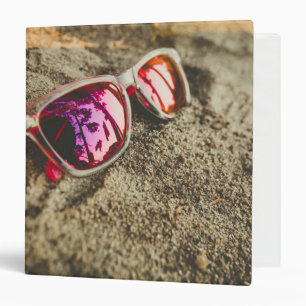 A Pair Of Fashionable Sunglasses On The Beach Binder