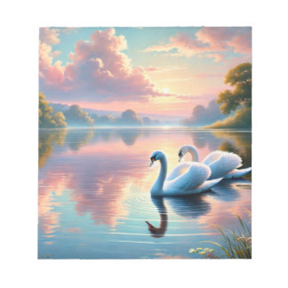 A pair of swans gliding on a serene lake notepad
