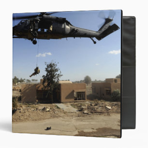 A pararescueman rappels from an HH-60 2 Binder