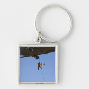 A pararescueman rappels from an HH-60 Keychain