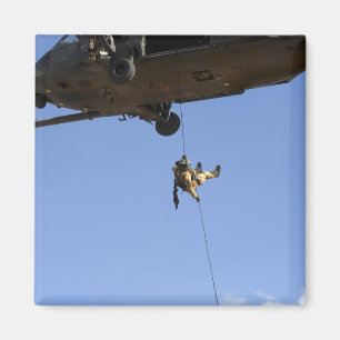A pararescueman rappels from an HH-60 Magnet