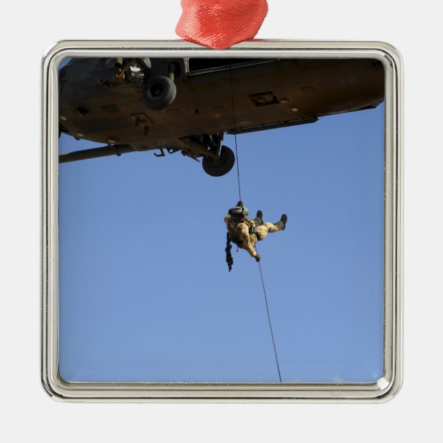 A pararescueman rappels from an HH-60 Metal Ornament (Front)