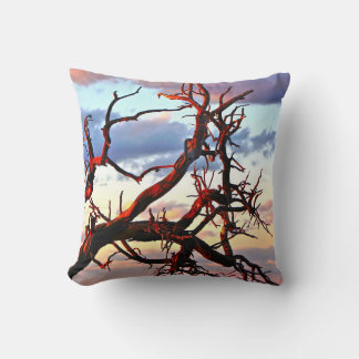 A PASTEL SUNSET WITH BARE TREE BRANCHES THROW PILLOW