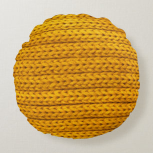 A pattern of yellow knitted fabric of yarn. round pillow