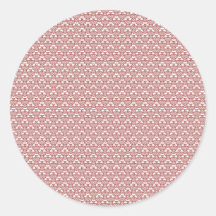 A patterned rug with red and brown motifs lies on  classic round sticker