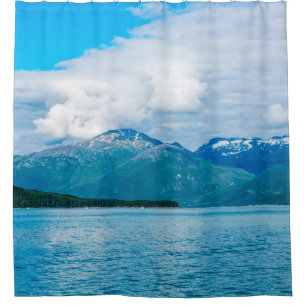 A peninsula of land covered in pine forest juts ou