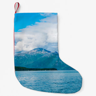 A peninsula of land covered in pine forest juts ou small christmas stocking