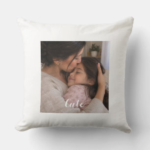 A picture of a mother kissing her young daughter throw pillow