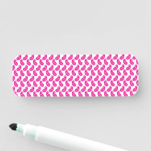 a pink and white background with a pattern name tag