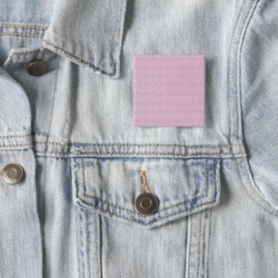 a pink and white background with wavy lines 2 inch square button