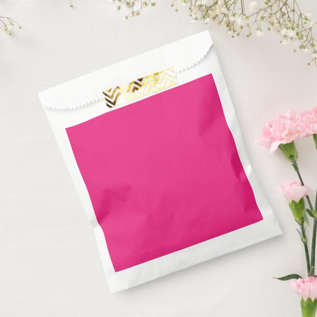 a pink background with a black favour bag (Sealed)