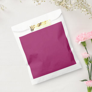 a pink background with a white favour bag
