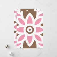 a pink flower on a brown background