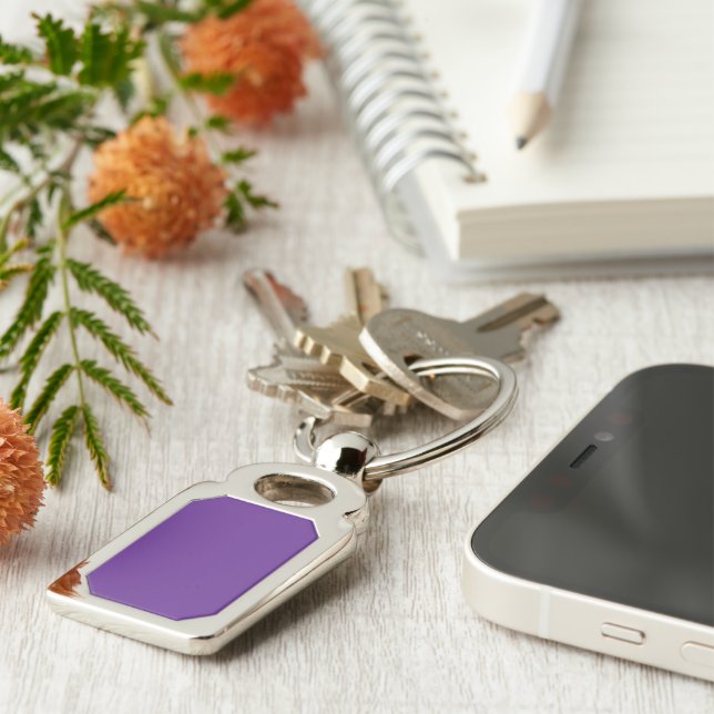 a purple background with a white border keychain (Side)