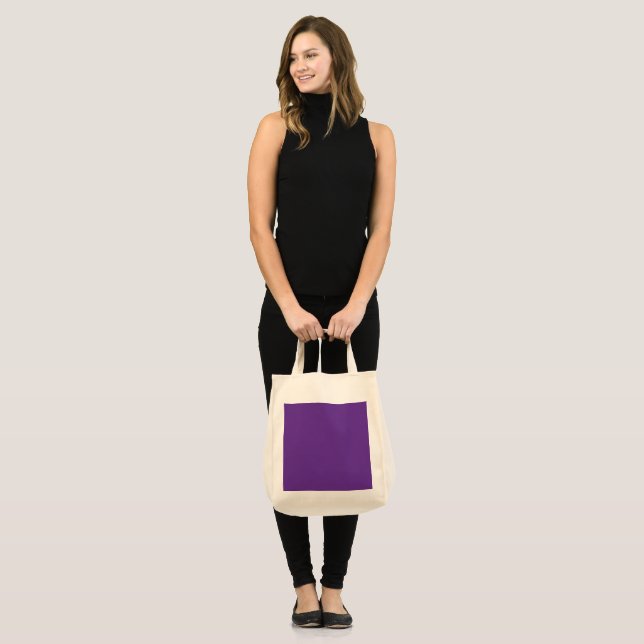 a purple background with a white border tote bag (Front (Model))