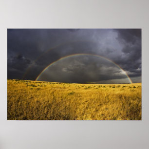 A rainbow appearing through a misty after noon poster