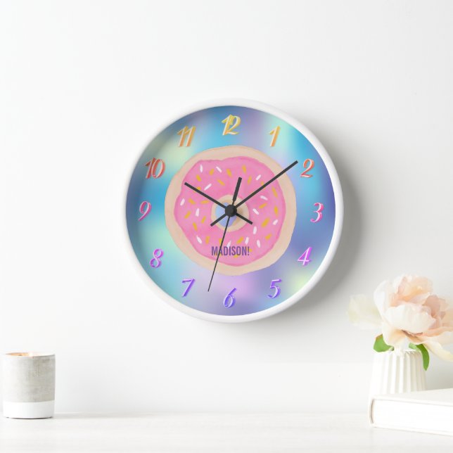 A rainbow of colours, a pink doughnut with a name  clock (Home)