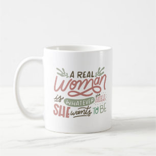 A REAL WOMEN IS WHATEVER THE HELL SHE WANTS TO BE COFFEE MUG