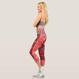 a red and black painting with a red heart on it capri leggings