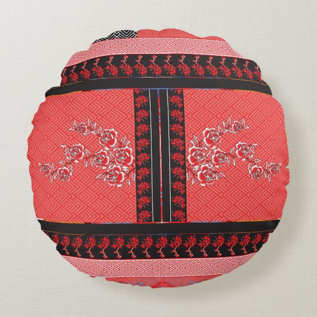 a red and black pattern with flowers on it round pillow (Front)