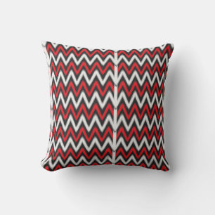 a red and black zigzag pattern on a white backgrou throw pillow