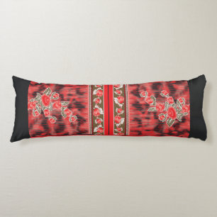 a red and green floral design on a black backgroun body pillow