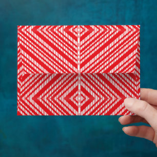 a red and white background with a diamond pattern envelope