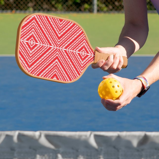 a red and white background with a diamond pattern pickleball paddle (Insitu)