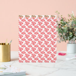 a red and white flower pattern on a white backgrou acrylic sign