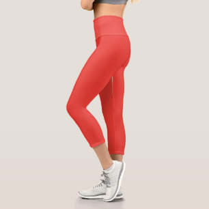 a red background with a white border capri leggings