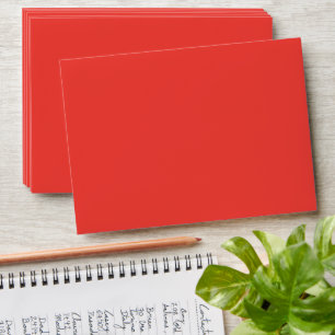a red background with a white border envelope
