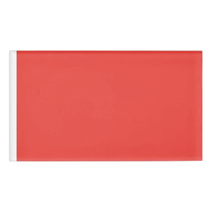 a red background with a white border name tag