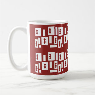 A red rug with a textured pattern is spread out on coffee mug