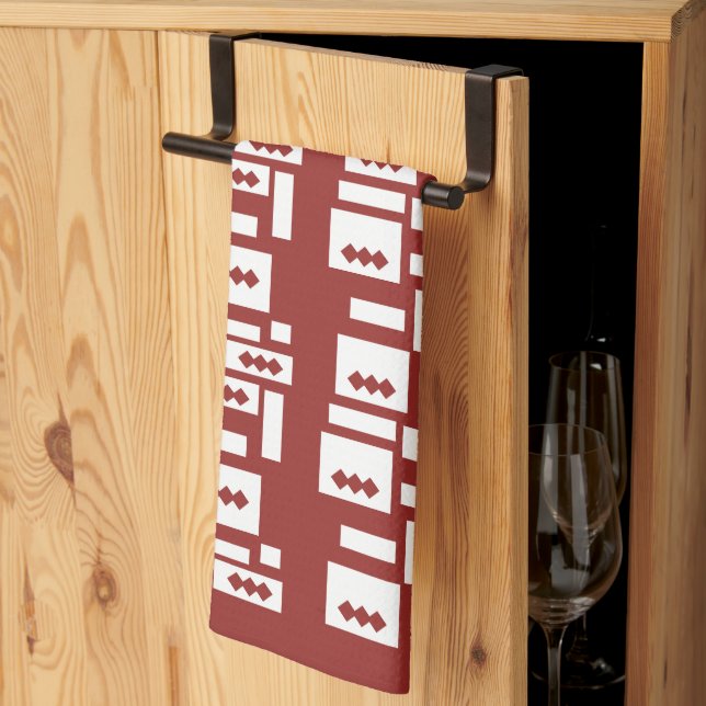 A red rug with a textured pattern is spread out on kitchen towel (Thirds Fold)