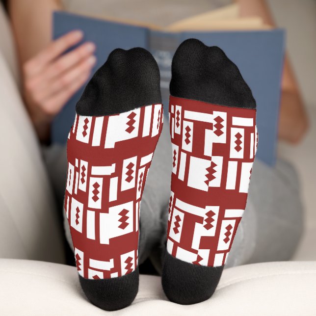 A red rug with a textured pattern is spread out on socks (Bottom)