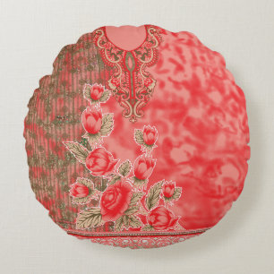 a red scarf with flowers on it round pillow