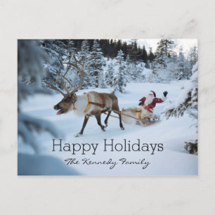 A reindeer pulling Santa Claus and his sleigh Holiday Postcard