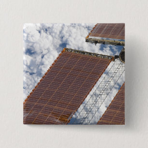 A repaired solar array 2 inch square button