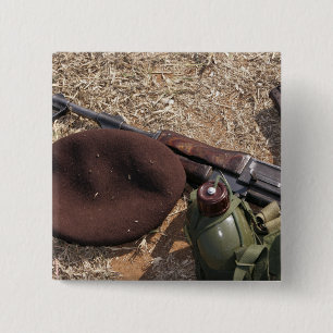 A rifle, military cover and canteen 2 inch square button