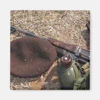 A rifle, military cover and canteen
