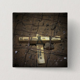 A road repair crew places a cross 2 inch square button