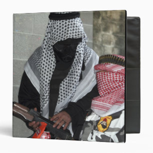 A role-playing enemy aggressor arms a dummy binder